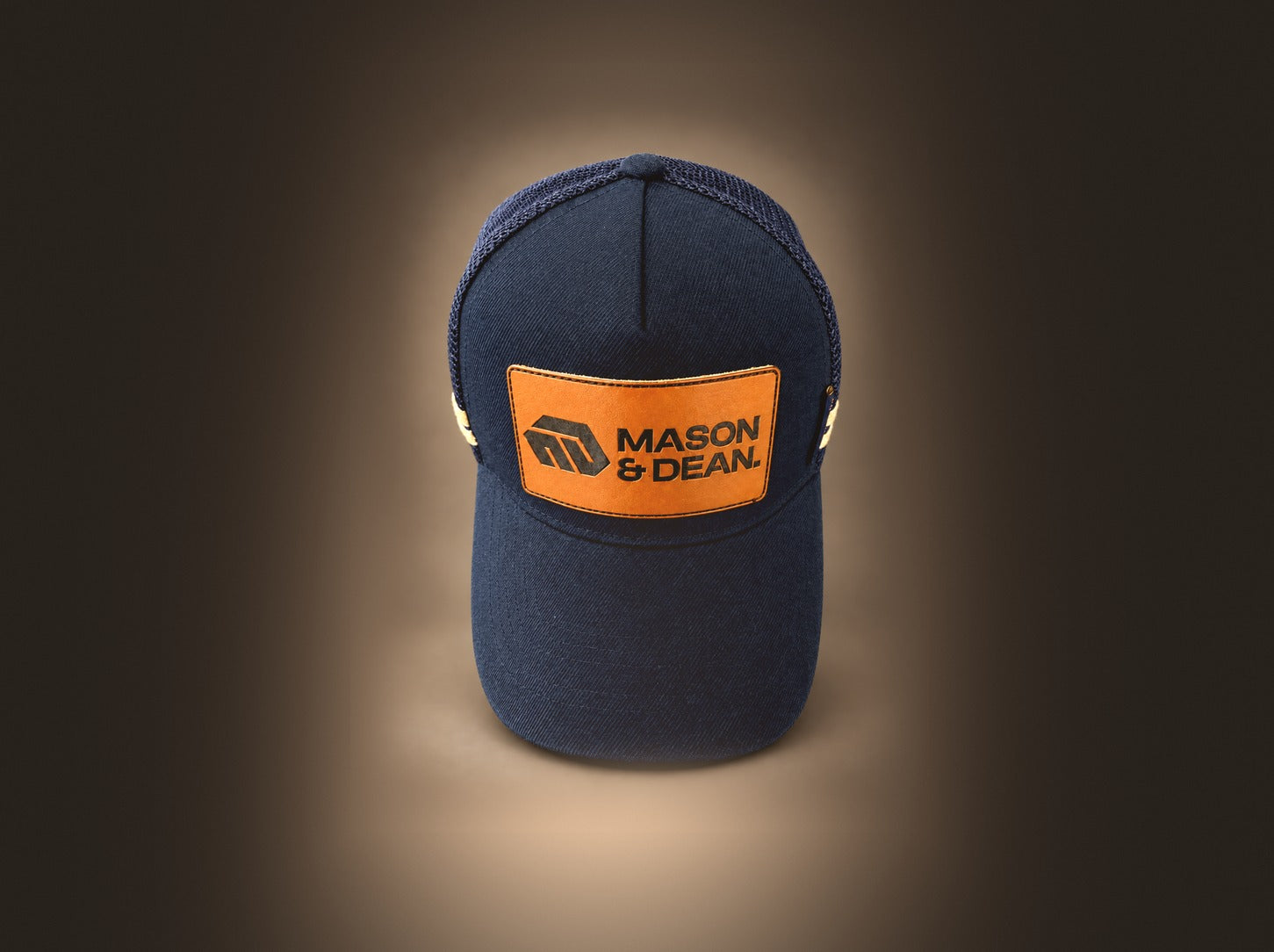 Front view of the Mason & Dean trucker cap showing the leather logo patch